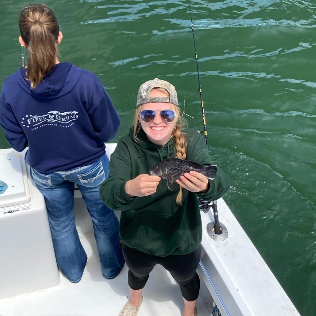 Girl holding sea bass